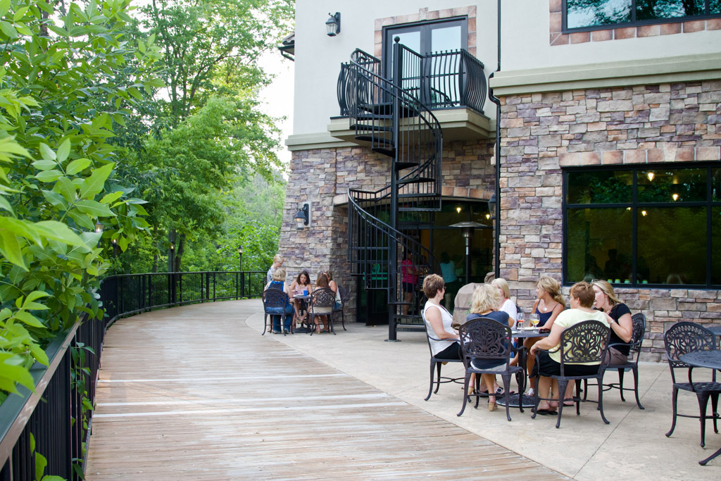 People sitting at tables in the Thought Design garden during a team workshop