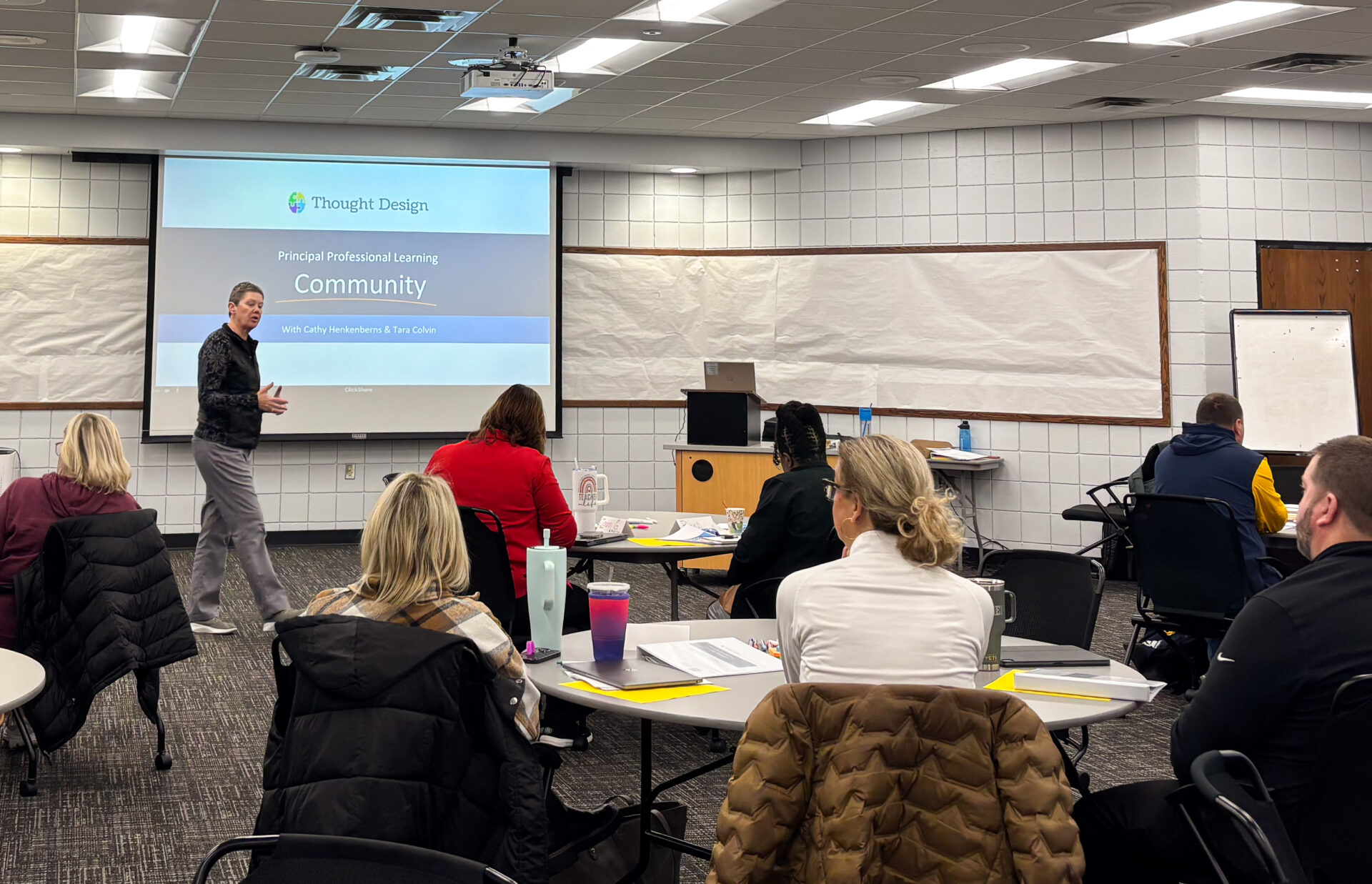 Teachers gathered at a gym for a Thought Design Workshop